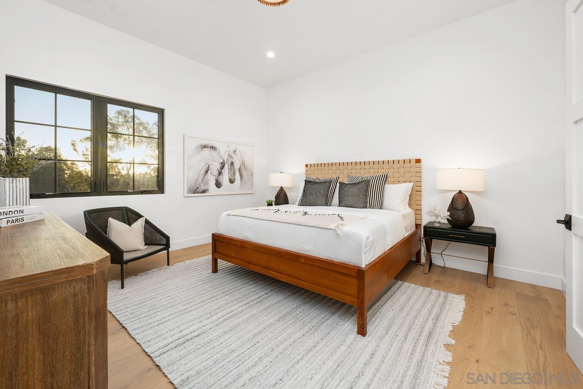 6691 Camino Saucito Rancho Santa Fe, CA 92067 - Photo 41 of 55 a bedroom with a bed and wooden floor