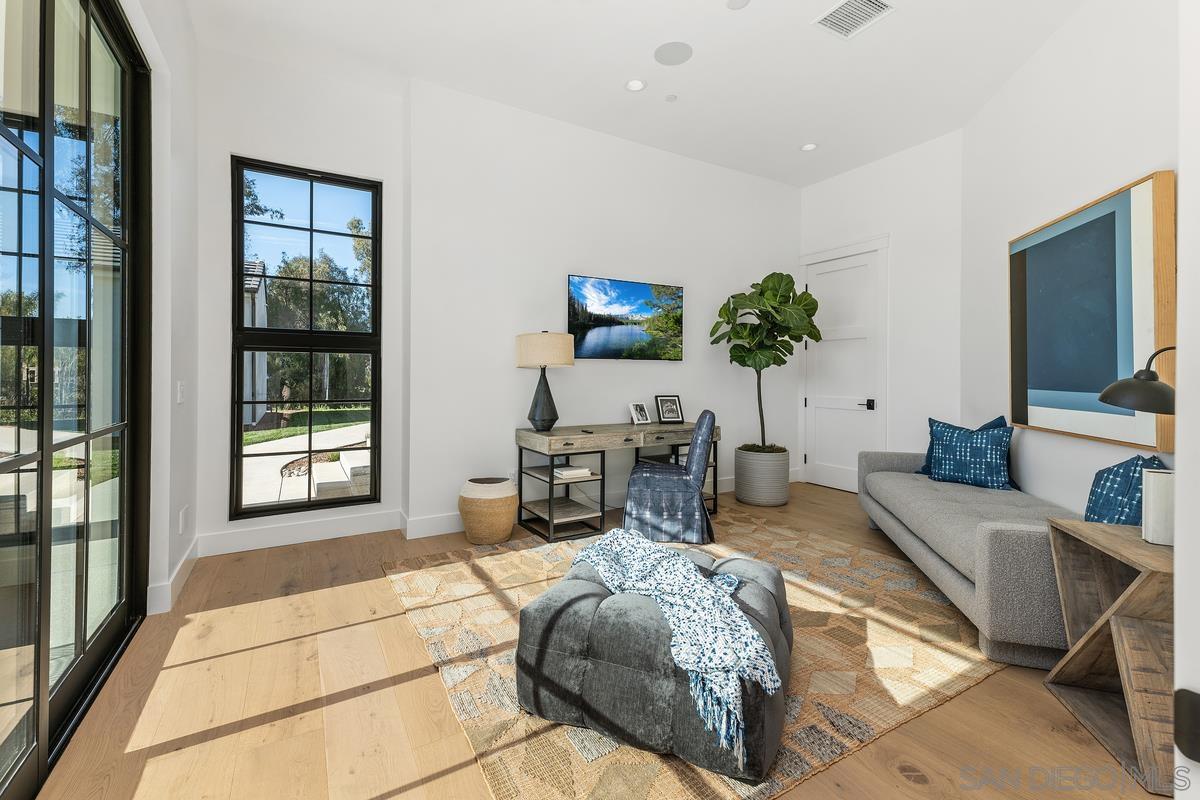 6691 Camino Saucito Rancho Santa Fe, CA 92067 - Photo 43 of 55 a living room with furniture a window and a flat screen tv
