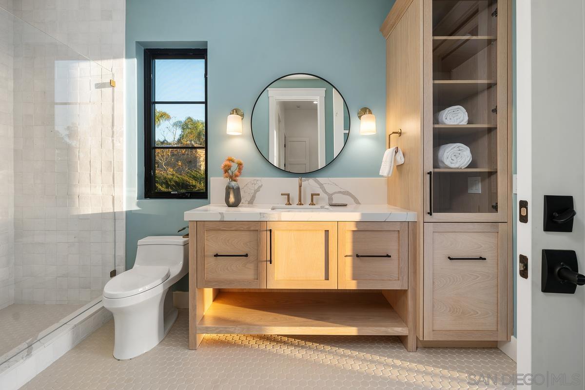 6691 Camino Saucito Rancho Santa Fe, CA 92067 - Photo 48 of 55 a bathroom with a toilet sink and mirror