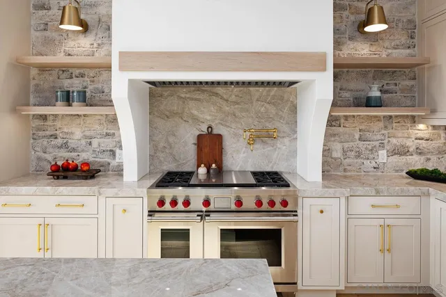 a stove top oven sitting inside of a kitchen