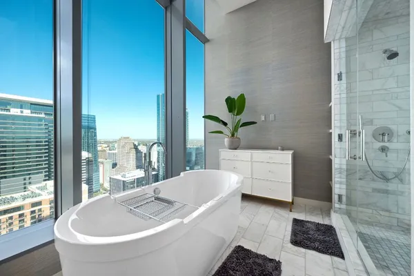 a bathroom with a granite countertop bathtub and a shower