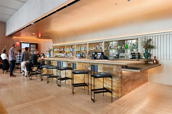 a living room filled with furniture and a large window