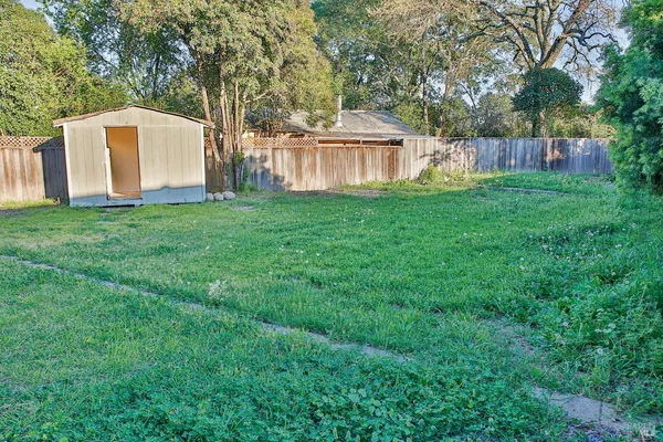 a view of a house with backyard and sitting area