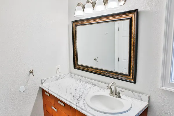 a bathroom with a sink vanity and a mirror