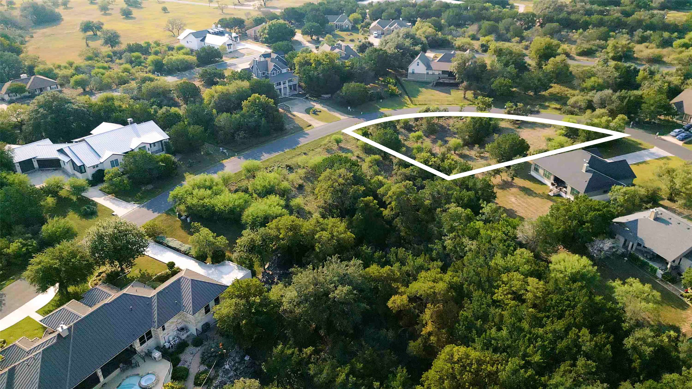 Lot 64 Wesley Ridge Drive Spicewood, TX 78669 - Photo 6 of 32 a view of a swimming pool with a yard and plants