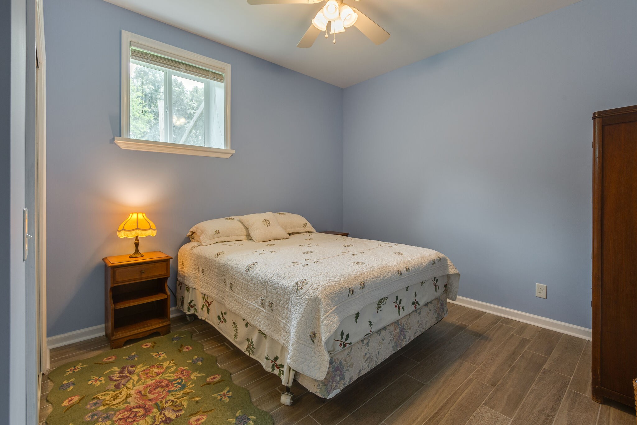 9953 Spring Creek Road Bon Aqua, TN 37025 - Photo 11 of 26 a bed sitting in a bedroom next to a window