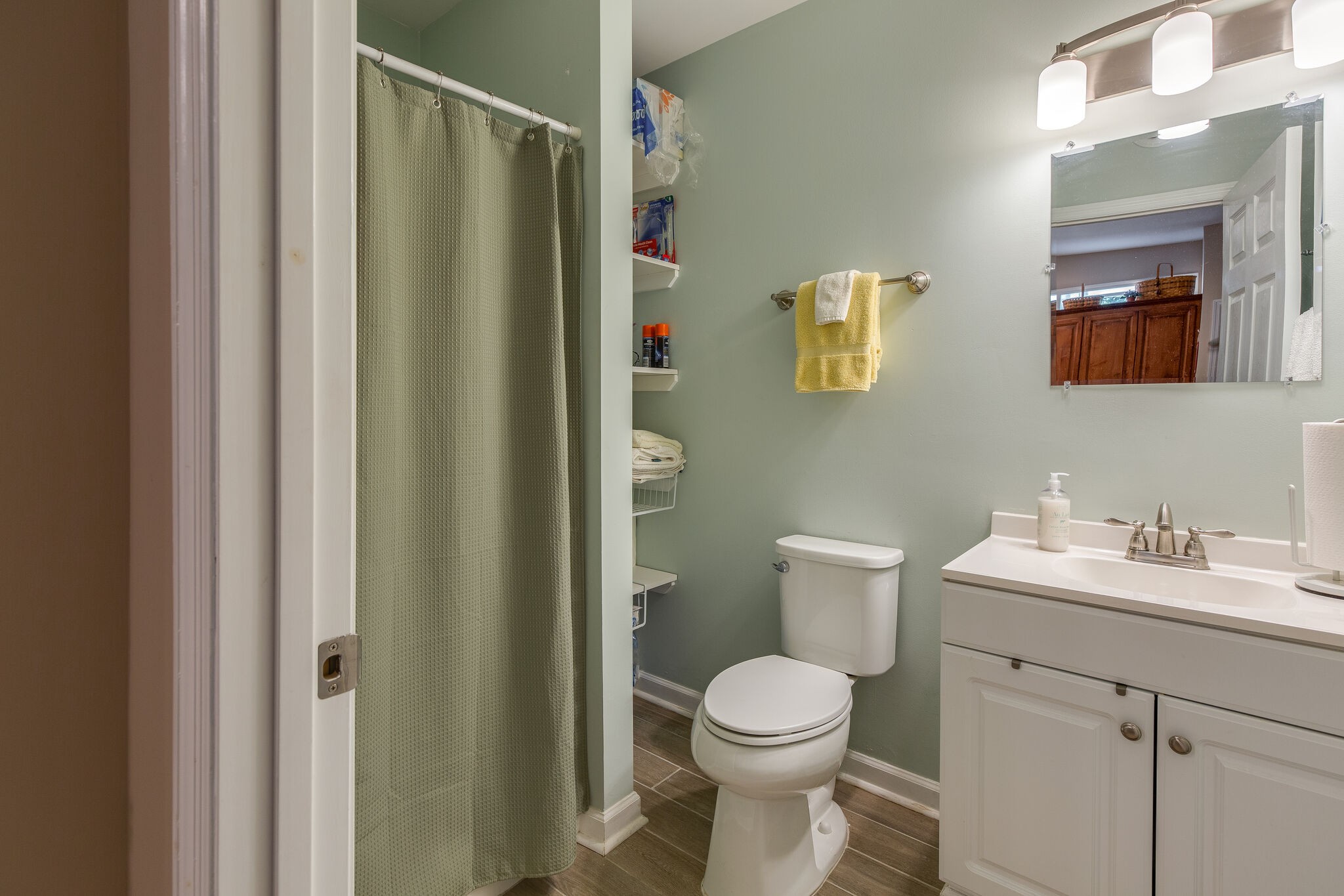 9953 Spring Creek Road Bon Aqua, TN 37025 - Photo 12 of 26 a bathroom with a toilet sink vanity and mirror