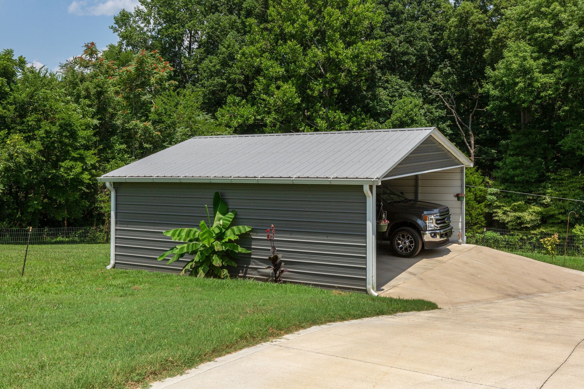 9953 Spring Creek Road Bon Aqua, TN 37025 - Photo 13 of 26 a view of a yard in front of a house with plants and large tree