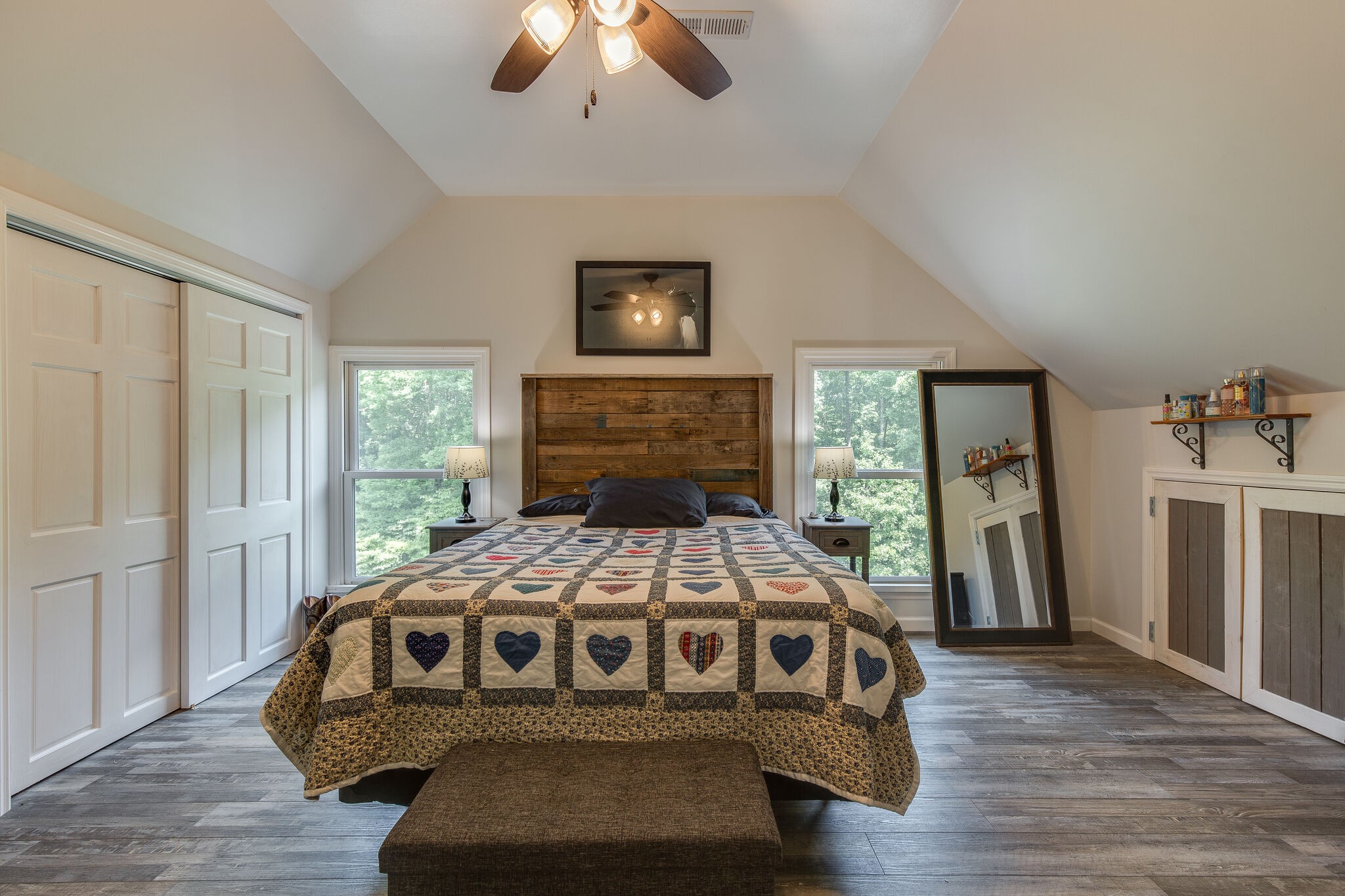 9953 Spring Creek Road Bon Aqua, TN 37025 - Photo 18 of 26 a bedroom with a bed and a chandelier