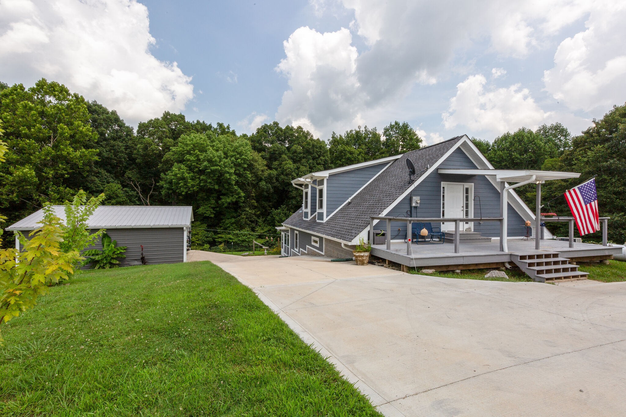 9953 Spring Creek Road Bon Aqua, TN 37025 - Photo 23 of 26 a view of a house with porch and a yard