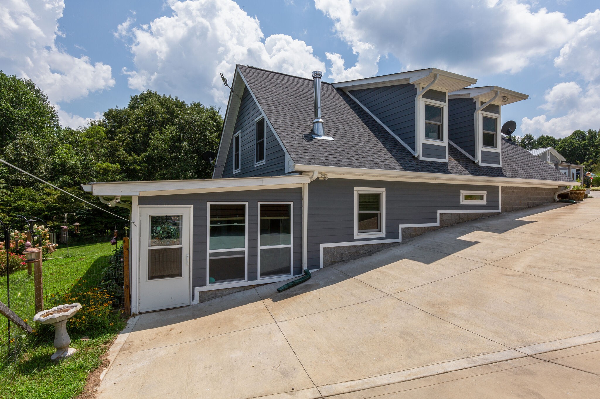 9953 Spring Creek Road Bon Aqua, TN 37025 - Photo 25 of 26 a front view of a house with a yard and garage