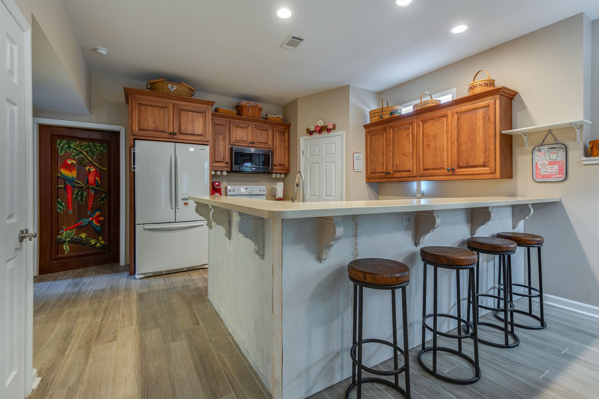 9953 Spring Creek Road Bon Aqua, TN 37025 - Photo 4 of 26 a kitchen with stainless steel appliances granite countertop a table chairs refrigerator and sink