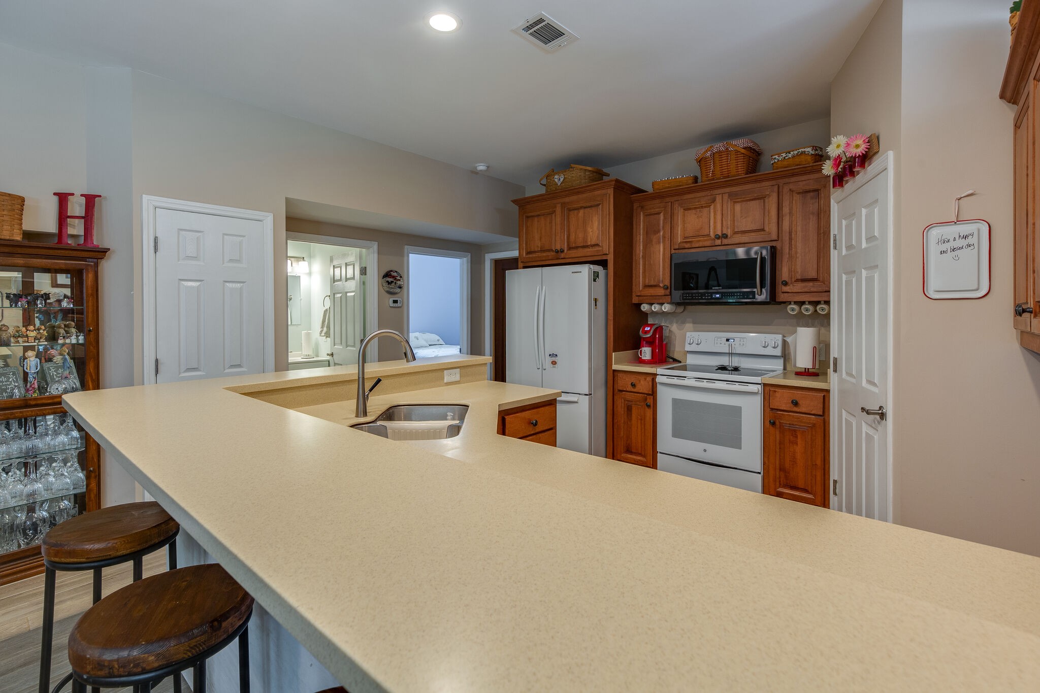 9953 Spring Creek Road Bon Aqua, TN 37025 - Photo 5 of 26 a kitchen with stainless steel appliances a stove a refrigerator a sink a dining table and chairs