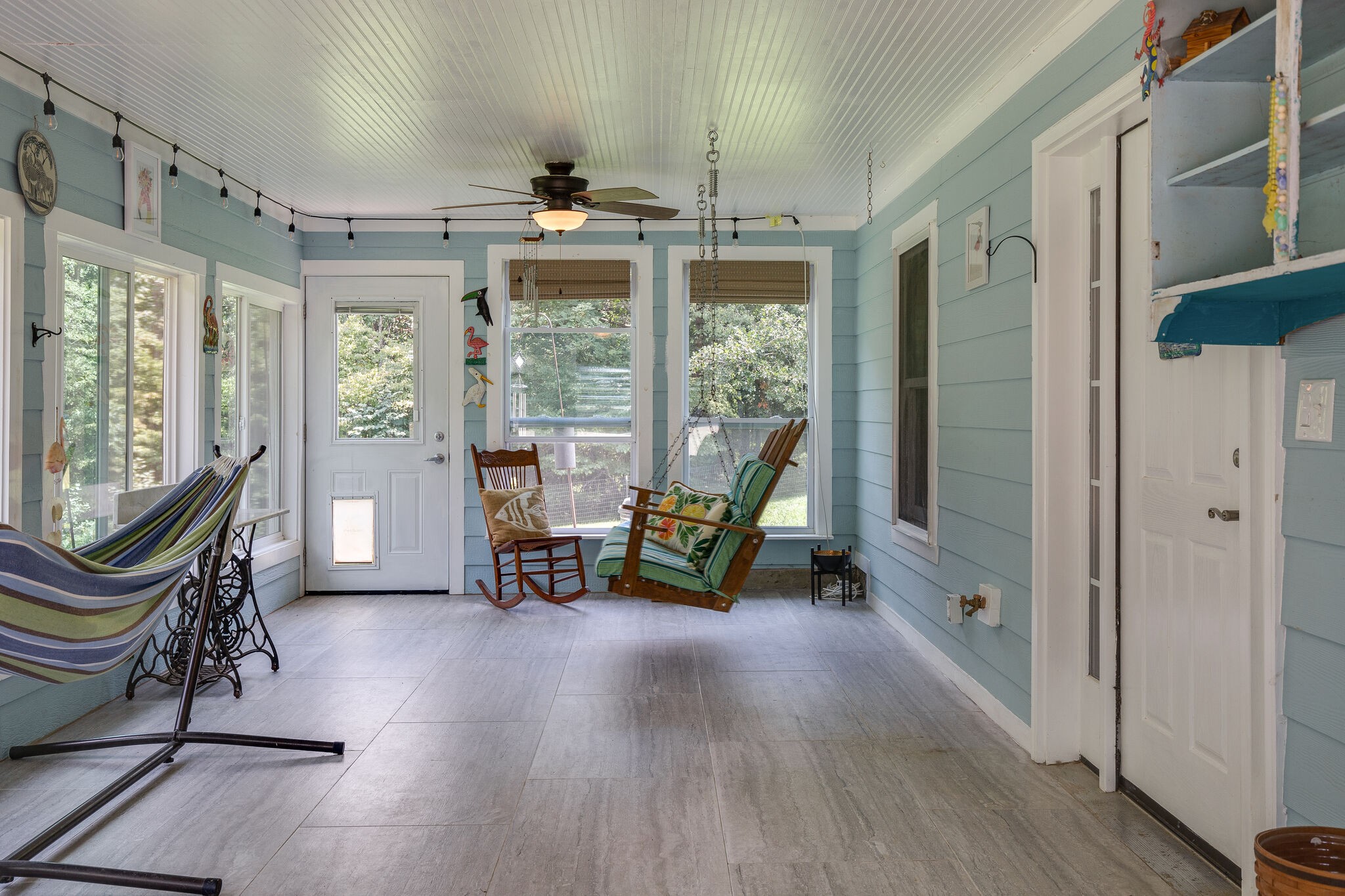 9953 Spring Creek Road Bon Aqua, TN 37025 - Photo 10 of 26 a view of a room with gym equipment and large windows