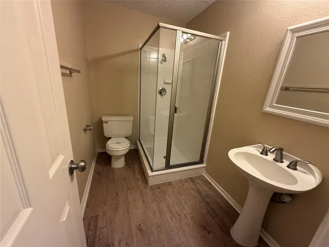 a bathroom with a sink mirror toilet and shower
