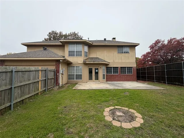 a view of a house with a yard and sitting area