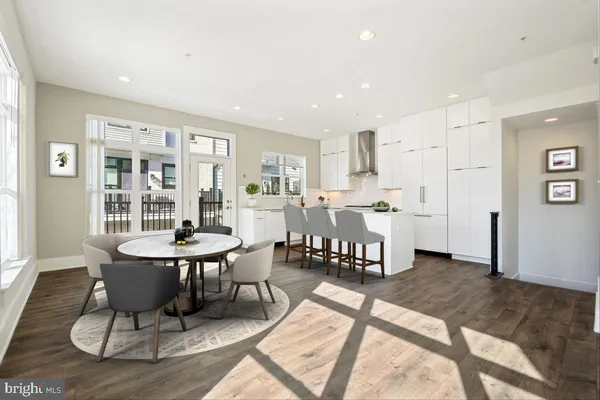 a living room with furniture and kitchen view