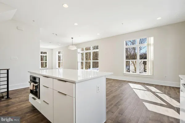 a view of kitchen with center island and wooden floor