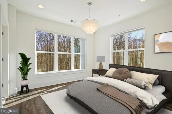 a bedroom with a bed and a large window