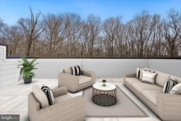 a outdoor living room with furniture and a potted plant