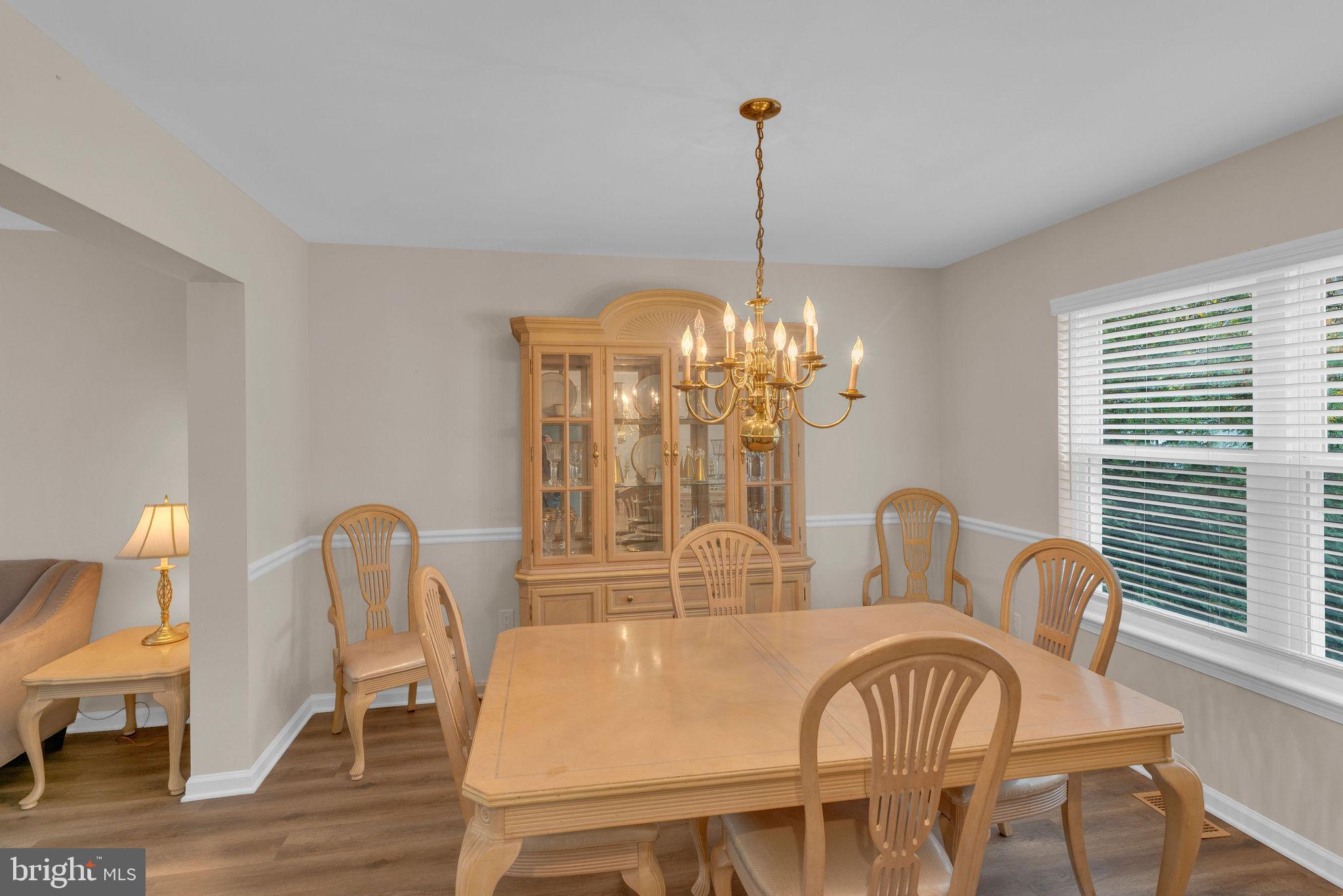 2158 Green Ridge Drive Warrington, PA 18976 - Photo 11 of 34 a view of a dining room with furniture a chandelier and wooden floor