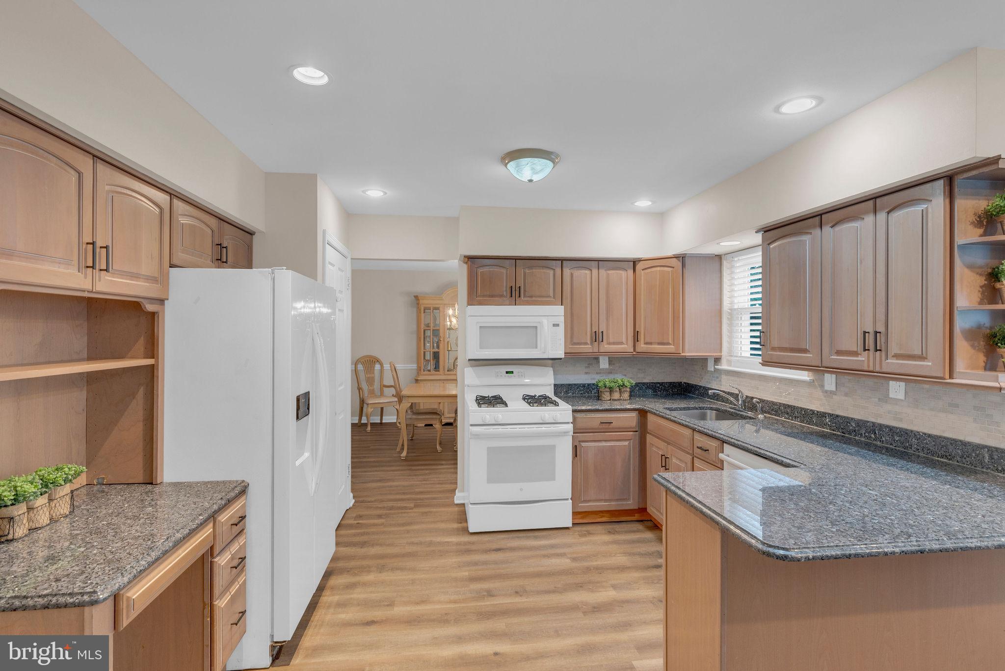 2158 Green Ridge Drive Warrington, PA 18976 - Photo 12 of 34 a kitchen with stainless steel appliances granite countertop a stove sink and cabinets
