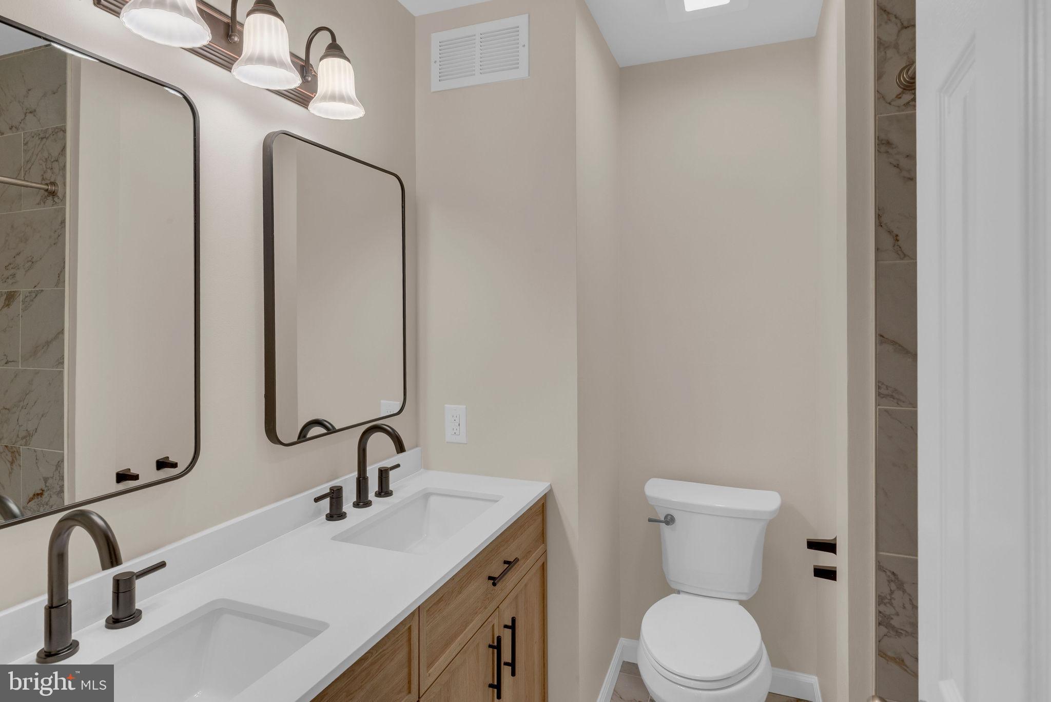 2158 Green Ridge Drive Warrington, PA 18976 - Photo 25 of 34 a bathroom with a toilet sink and mirror