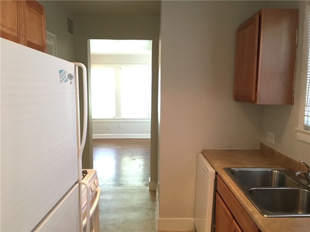 812 East 30th Street, Unit 2 Austin, TX 78705 - Photo 15 of 16 a kitchen with a refrigerator and a sink