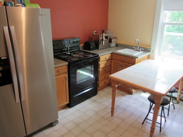 58 South Main Street Ashburnham, MA 01430 - Photo 16 of 20 a kitchen with stainless steel appliances granite countertop a refrigerator and a stove top oven