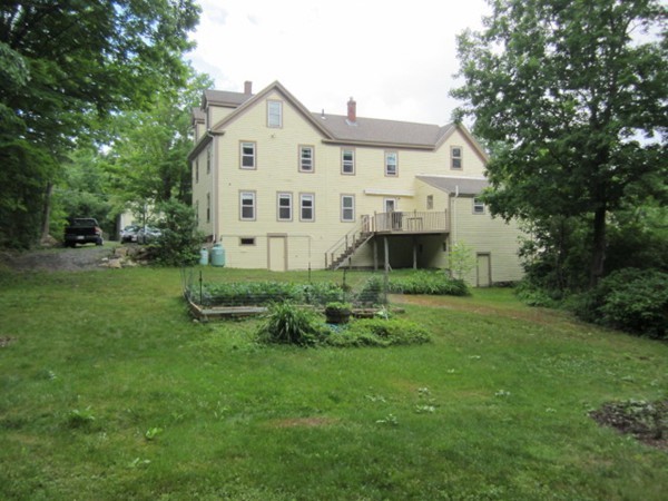 58 South Main Street Ashburnham, MA 01430 - Photo 5 of 20 a front view of a house with a yard and trees