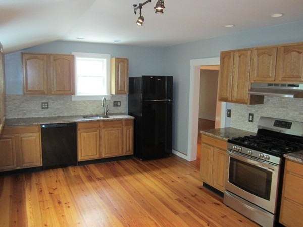 58 South Main Street Ashburnham, MA 01430 - Photo 6 of 20 a kitchen with stainless steel appliances granite countertop a stove a refrigerator a sink a microwave and wooden floors