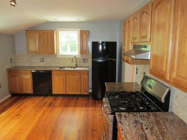 58 South Main Street Ashburnham, MA 01430 - Photo 7 of 20 a kitchen with granite countertop a refrigerator a stove a sink and wooden floor