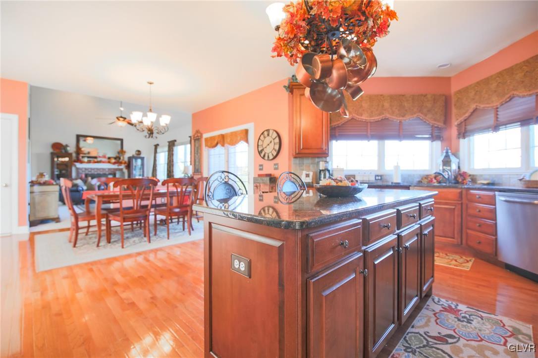 580 Rockbridge Road Nazareth, PA 18064 - Photo 11 of 30 a kitchen with stainless steel appliances granite countertop a table chairs and a barbeque