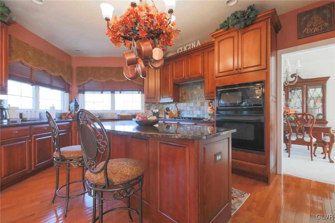580 Rockbridge Road Nazareth, PA 18064 - Photo 13 of 30 a kitchen with granite countertop a table chairs stove and cabinets
