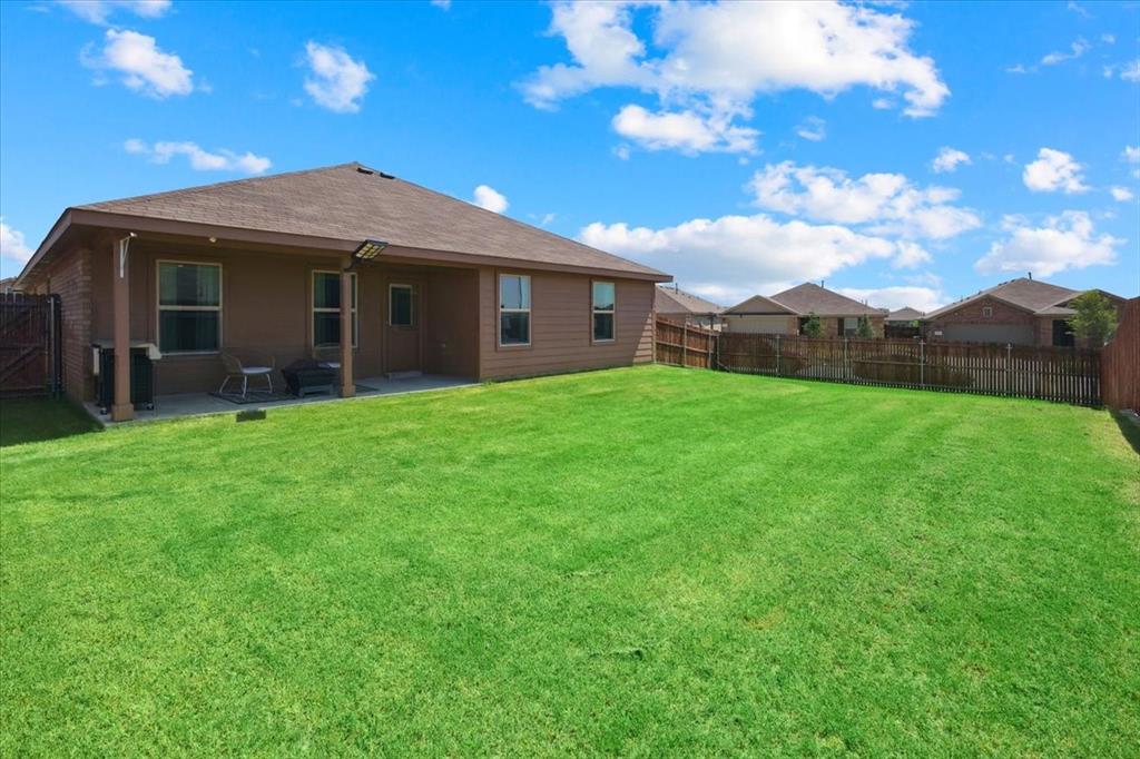 16733 Portage Street Justin, TX 76247 - Photo 17 of 39 a view of a yard in front of a house with large tree