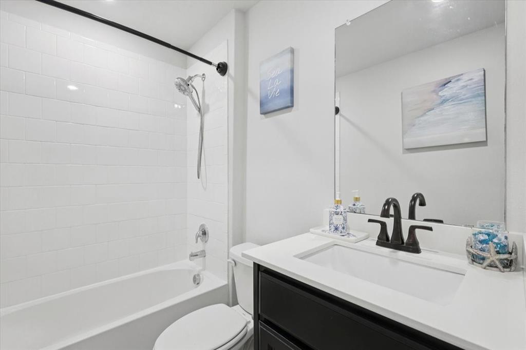 16733 Portage Street Justin, TX 76247 - Photo 23 of 39 a bathroom with a sink a toilet and shower