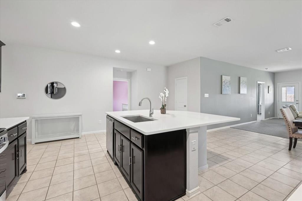 16733 Portage Street Justin, TX 76247 - Photo 29 of 39 a utility room with a sink a stove and cabinets