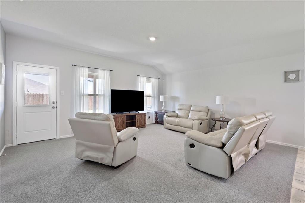 16733 Portage Street Justin, TX 76247 - Photo 9 of 39 a living room with furniture and a flat screen tv
