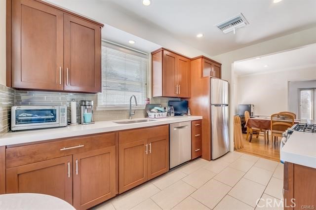 5646-5646 Vesper Avenue Sherman Oaks, CA 91411 - Photo 13 of 17 a kitchen with refrigerator cabinets and chairs