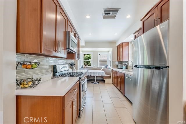 5646-5646 Vesper Avenue Sherman Oaks, CA 91411 - Photo 10 of 17 a kitchen with refrigerator and cabinets