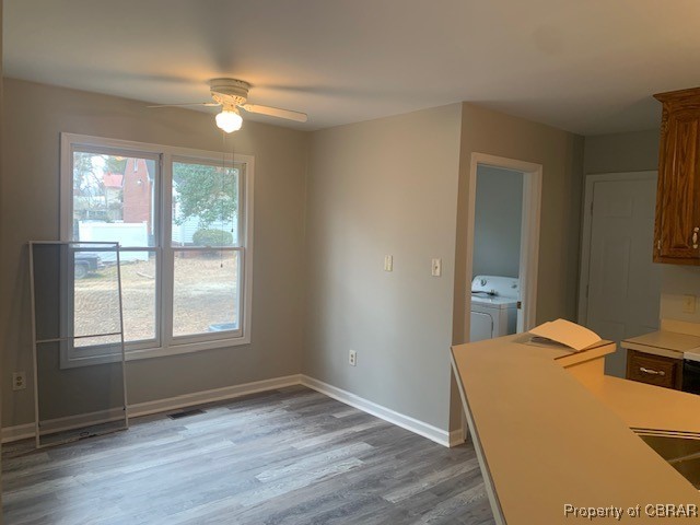 8035 Belroi Road Gloucester, VA 23061 - Photo 7 of 16 Unfurnished dining area with hardwood / wood-style flooring, ceiling fan, and washer and clothes dryer