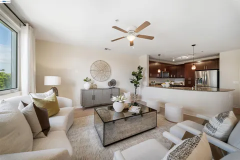 a living room with furniture a chandelier and a large window