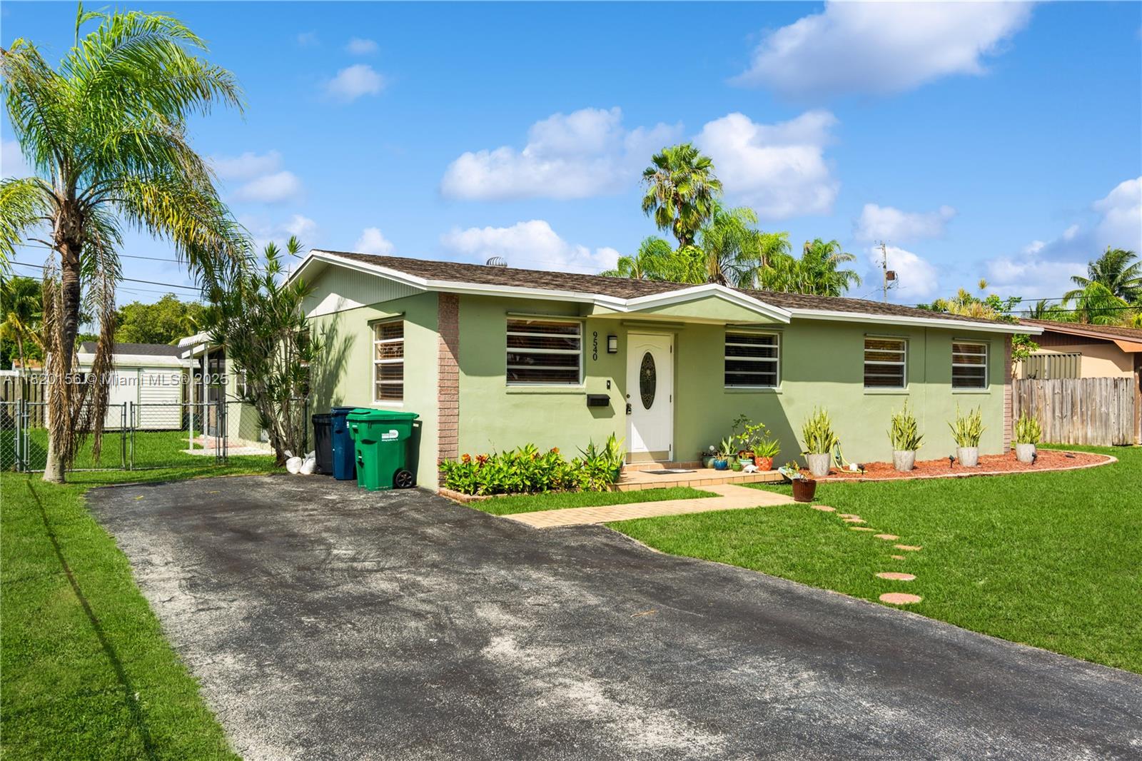 9540 Lisa Road Cutler Bay, FL 33157 - Photo 5 of 30 a front view of a house with a yard and potted plants