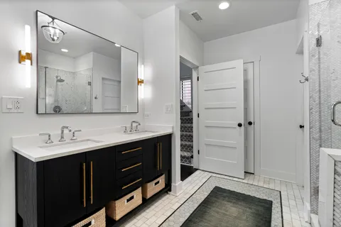 a bathroom with a double vanity sink a and a mirror