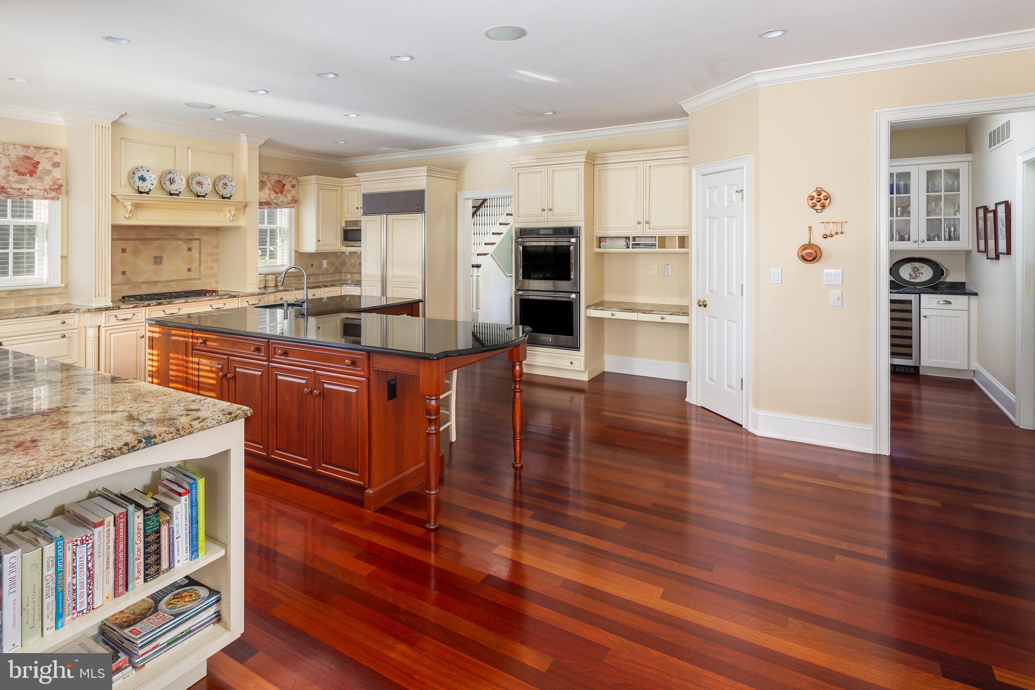 152 Grubb Road Malvern, PA 19355 - Photo 24 of 74 a kitchen with stainless steel appliances granite countertop a refrigerator a stove and a wooden floors