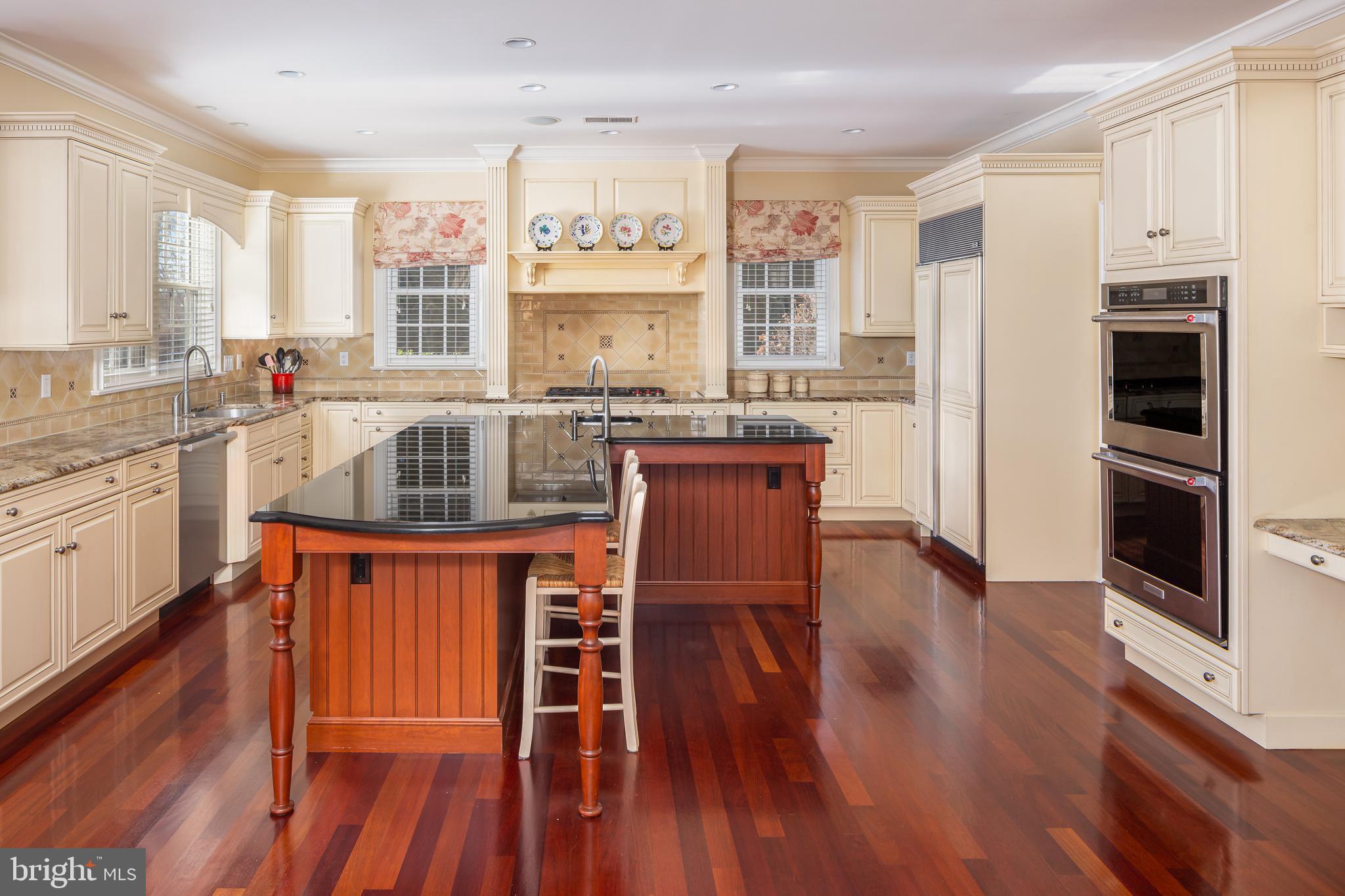 152 Grubb Road Malvern, PA 19355 - Photo 30 of 74 a kitchen with stainless steel appliances granite countertop wooden floors and white cabinets