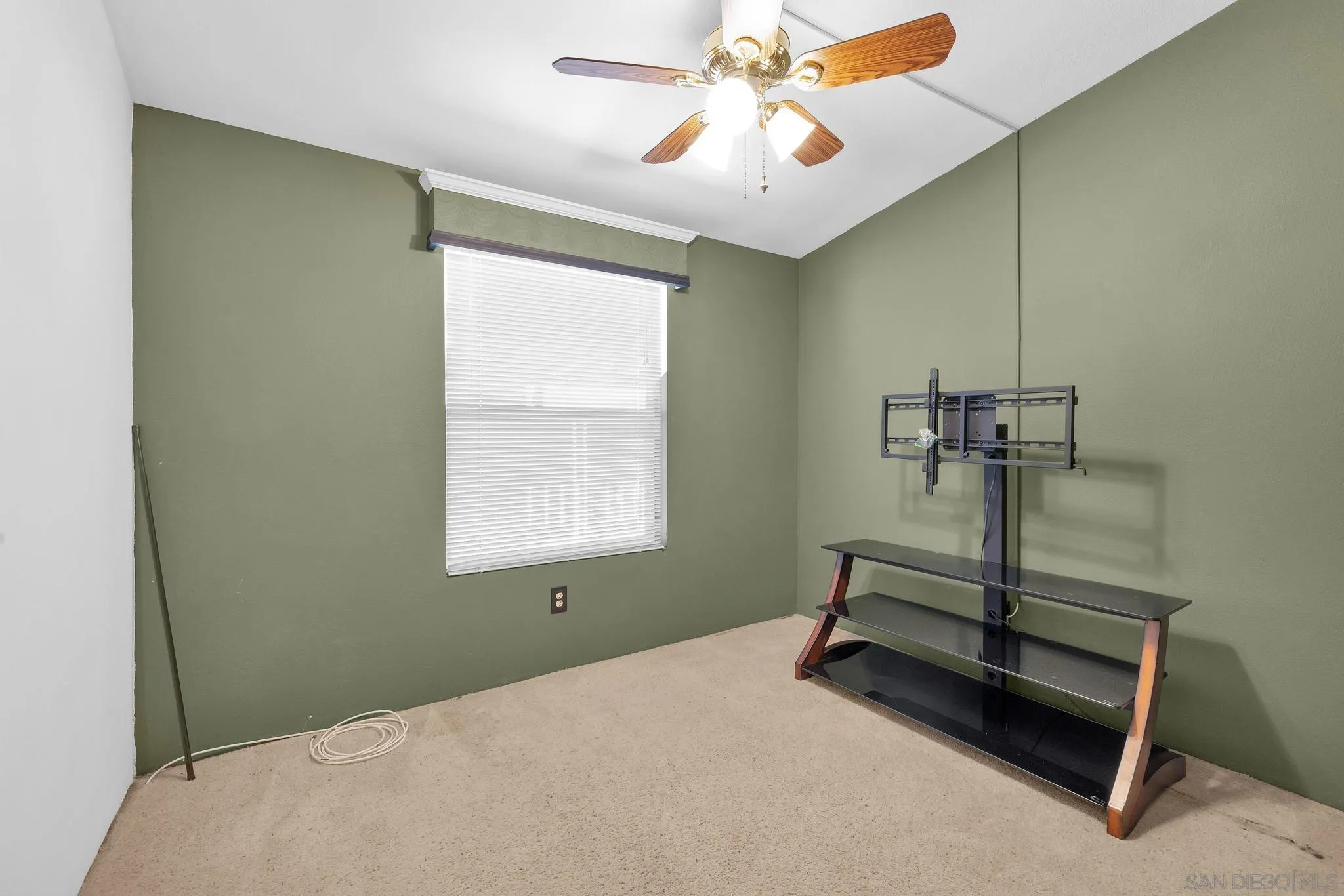 10880 Highway 67, Unit 74 Lakeside, CA 92040 - Photo 12 of 18 a bedroom with a bed and a chandelier