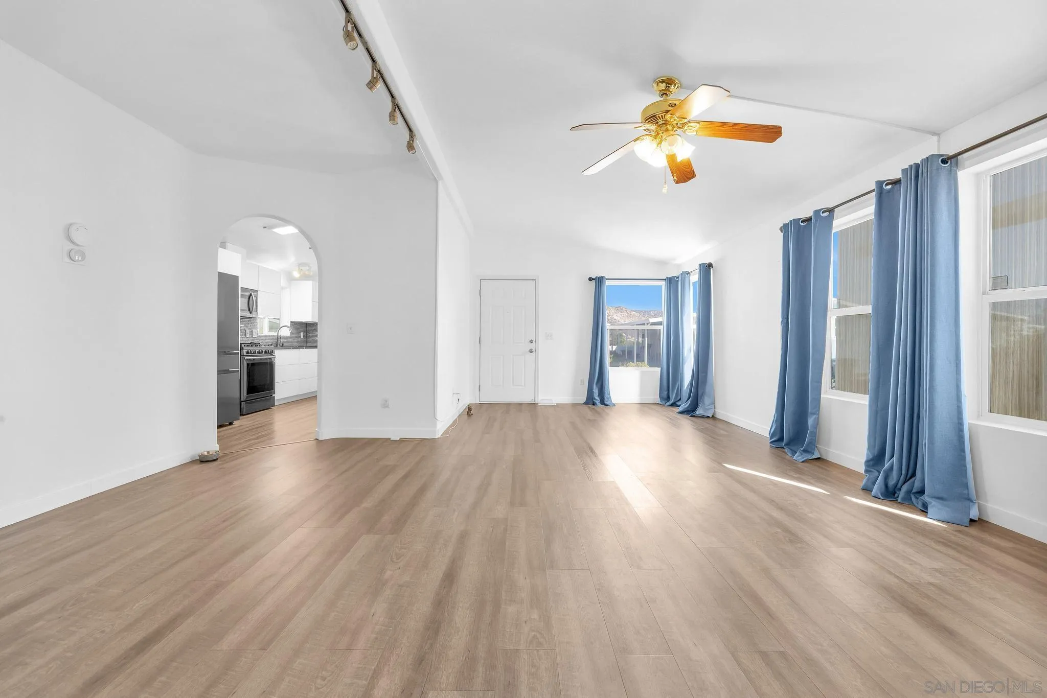 10880 Highway 67, Unit 74 Lakeside, CA 92040 - Photo 15 of 18 a view of an empty room with wooden floor and a window