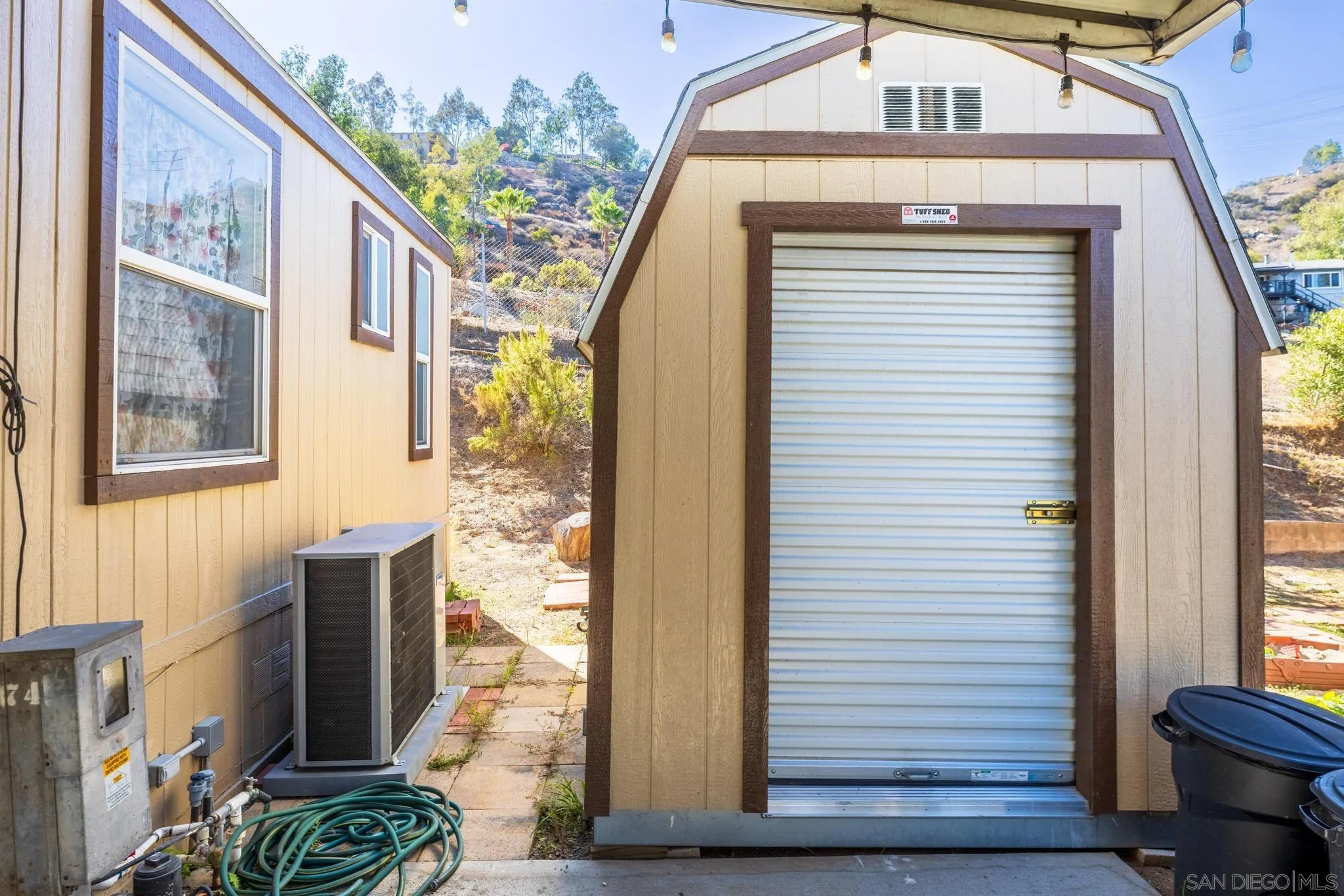 10880 Highway 67, Unit 74 Lakeside, CA 92040 - Photo 3 of 18 a front view of a house with a yard