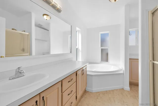 a bathroom with a double vanity sink a mirror and a